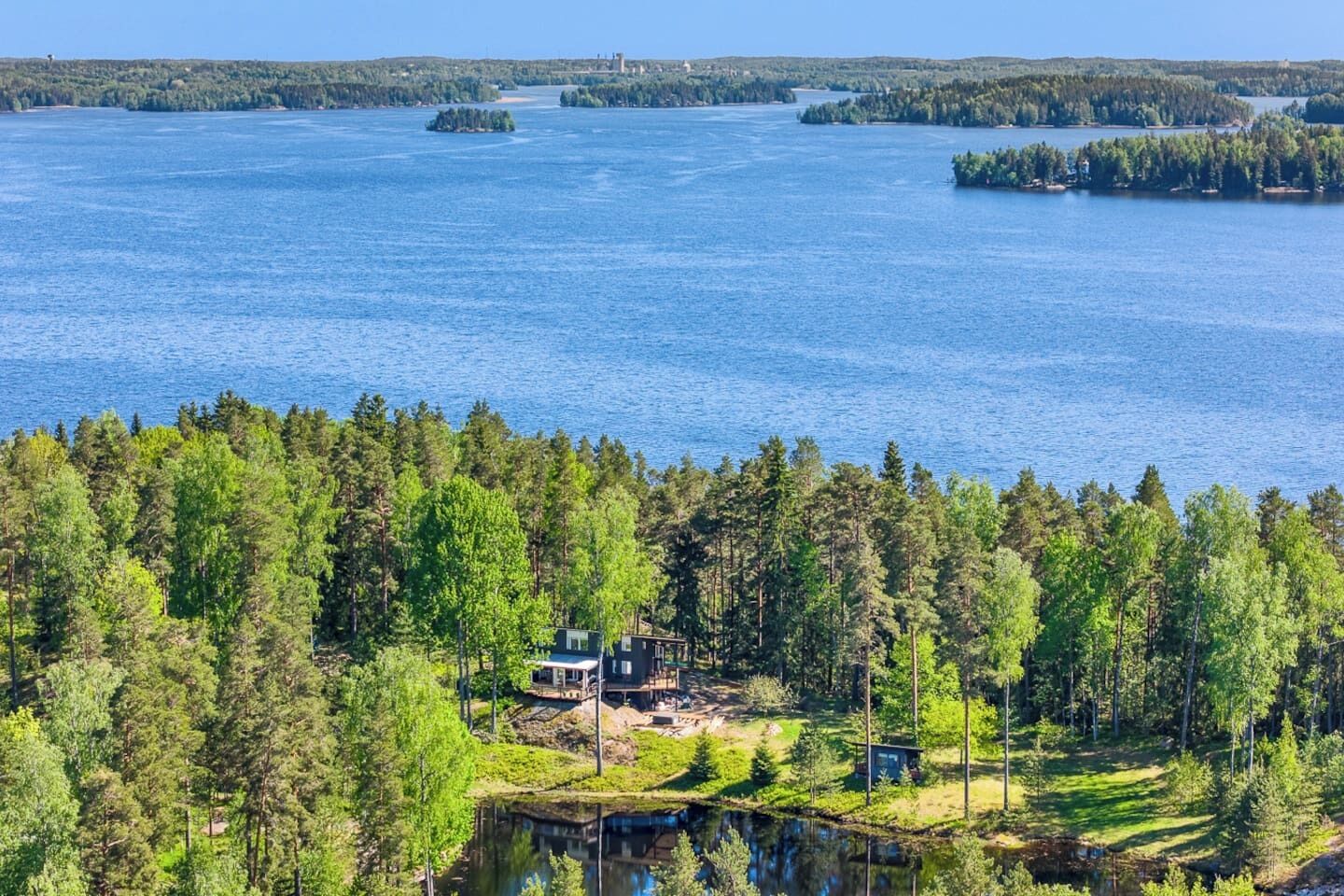 A lakeside property with a cabin and a dock extending into the water.