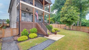 A two-story house with a balcony, a flag, and a well-maintained lawn. - WFH-Friendly Studio - 5 Mi to Downtown Atlanta! (Atlanta)