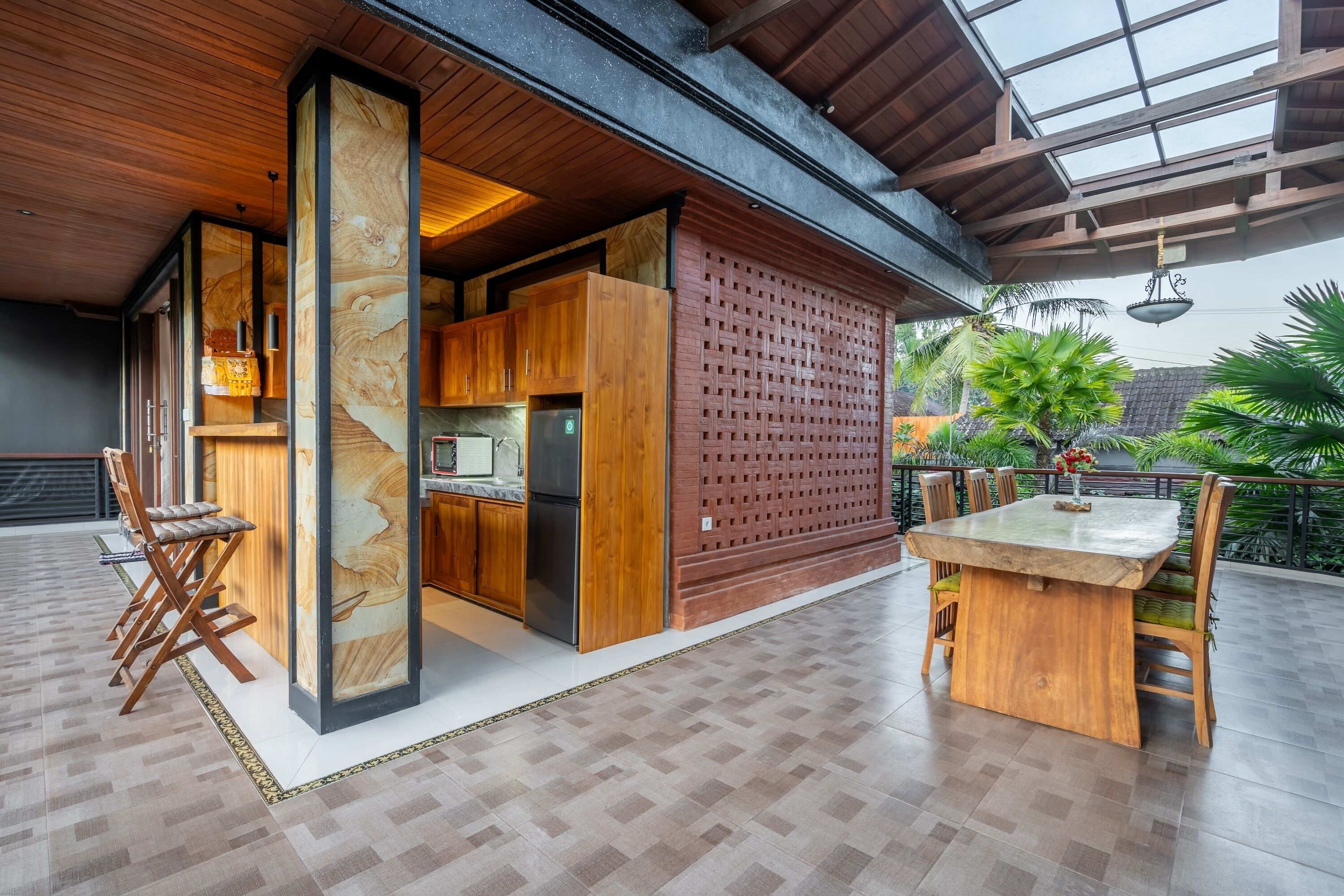 A spacious kitchen with wooden cabinets and a built-in refrigerator.