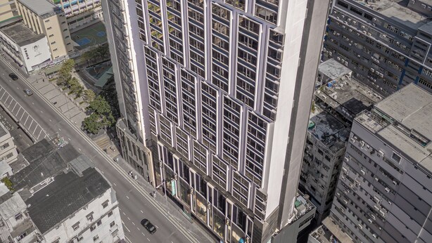 A high-rise building with a grid of windows and a rooftop terrace. - Weave Studios - Kowloon West (Kowloon)