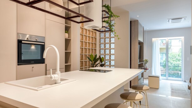 A modern kitchen with a large island, built-in oven, and bar stools. - Culture Retreat 1 near Archaeological Museum (Athina)