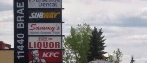 A commercial building with a sign listing various businesses including a veterinary clinic, pet valuation, and a Subway.