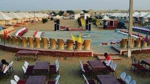 A beachside area with outdoor seating and a pool. - Golden Rose Heritage Desert Safari Camp  (Jaisalmer)