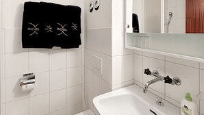 A bathroom with a white toilet, a sink, and a shower. - Haus Cresta - Zermatt Paradise- Swiss Alps (Zermatt)