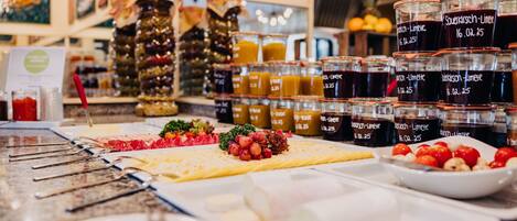 A buffet with various food items and condiments.