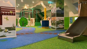 An indoor play area with a slide, climbing structures, and a soft play floor. - Chalet With Private Jetty (Giethoorn)
