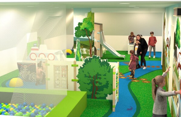 A children's play area with a slide, climbing wall, and ball pit.