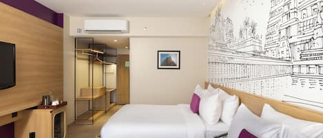 A hotel room with two beds, a TV, a wardrobe, and a mural.