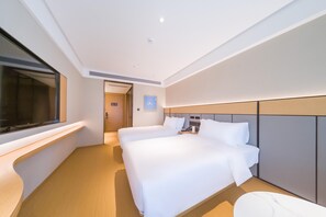 A modern hotel room with two single beds, a large window, a bedside table, and a built-in TV. - Ji Hotel Shenzhen Baoan Pingzhou Subway Station (Shenzhen)
