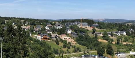 A residential area with houses, a train track, and a large building with a crane.