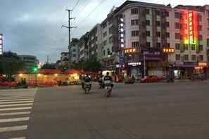 A street scene with buildings, a crosswalk, and vehicles.