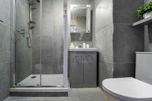 Shower, hair dryer, towels, shampoo