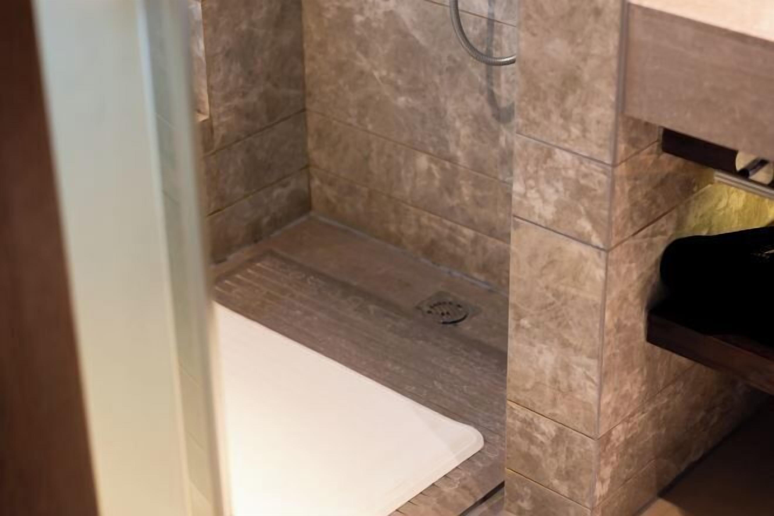 A bathroom with a shower, a bathtub, and a sink.