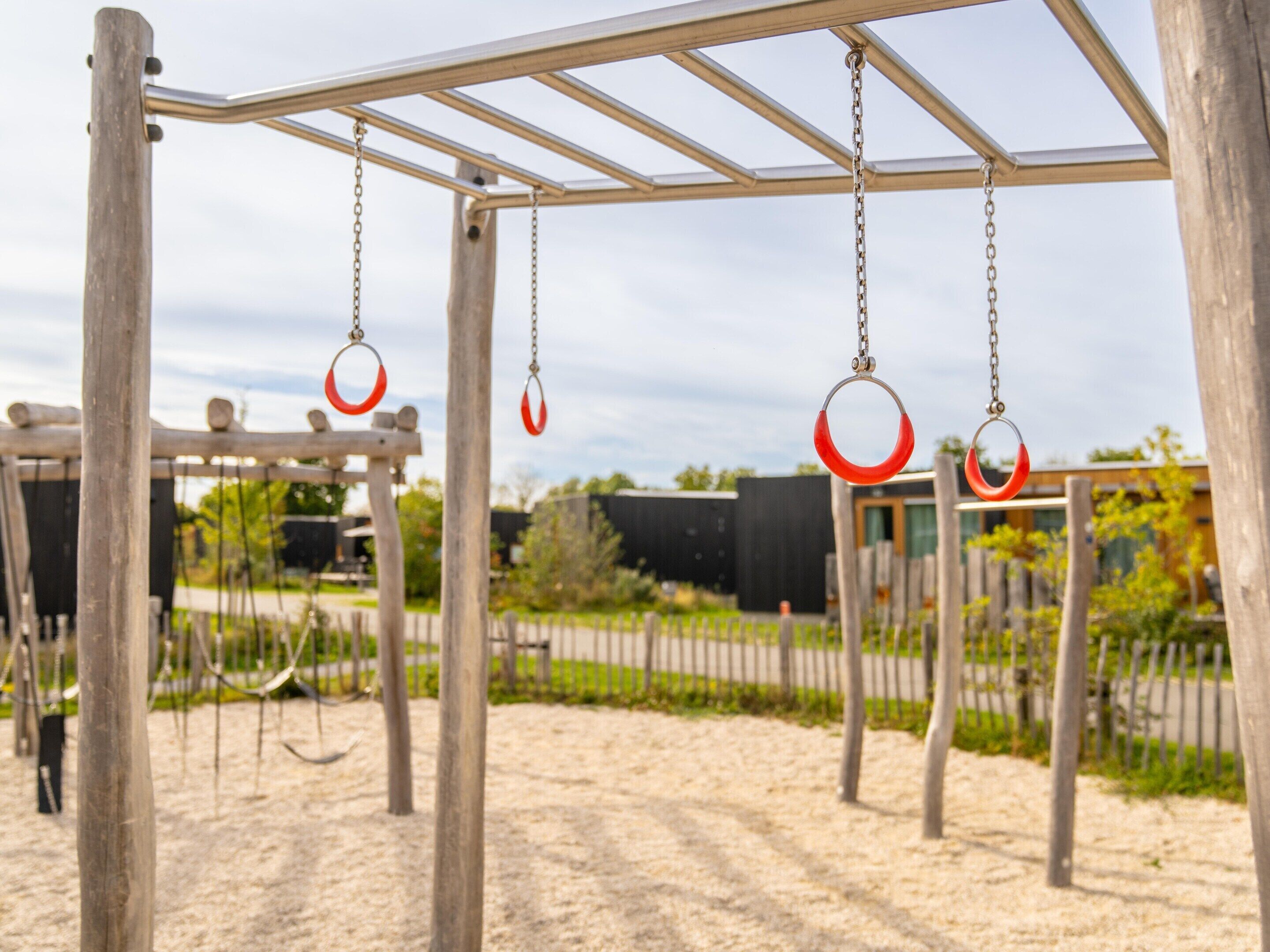 A playground with swings and a climbing structure.
