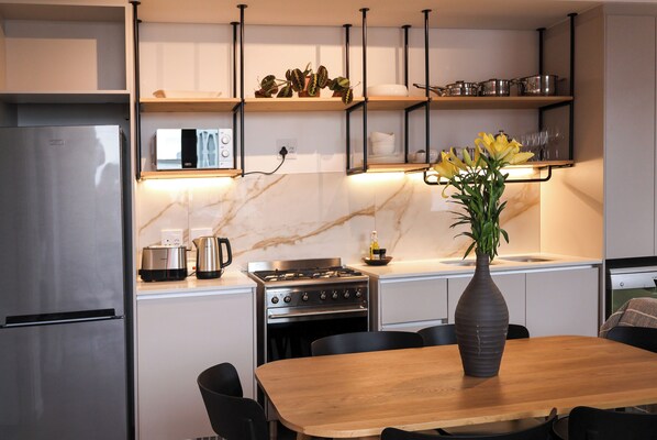Enjoy meals in the kitchen with an oven, gas stove, and dining table.