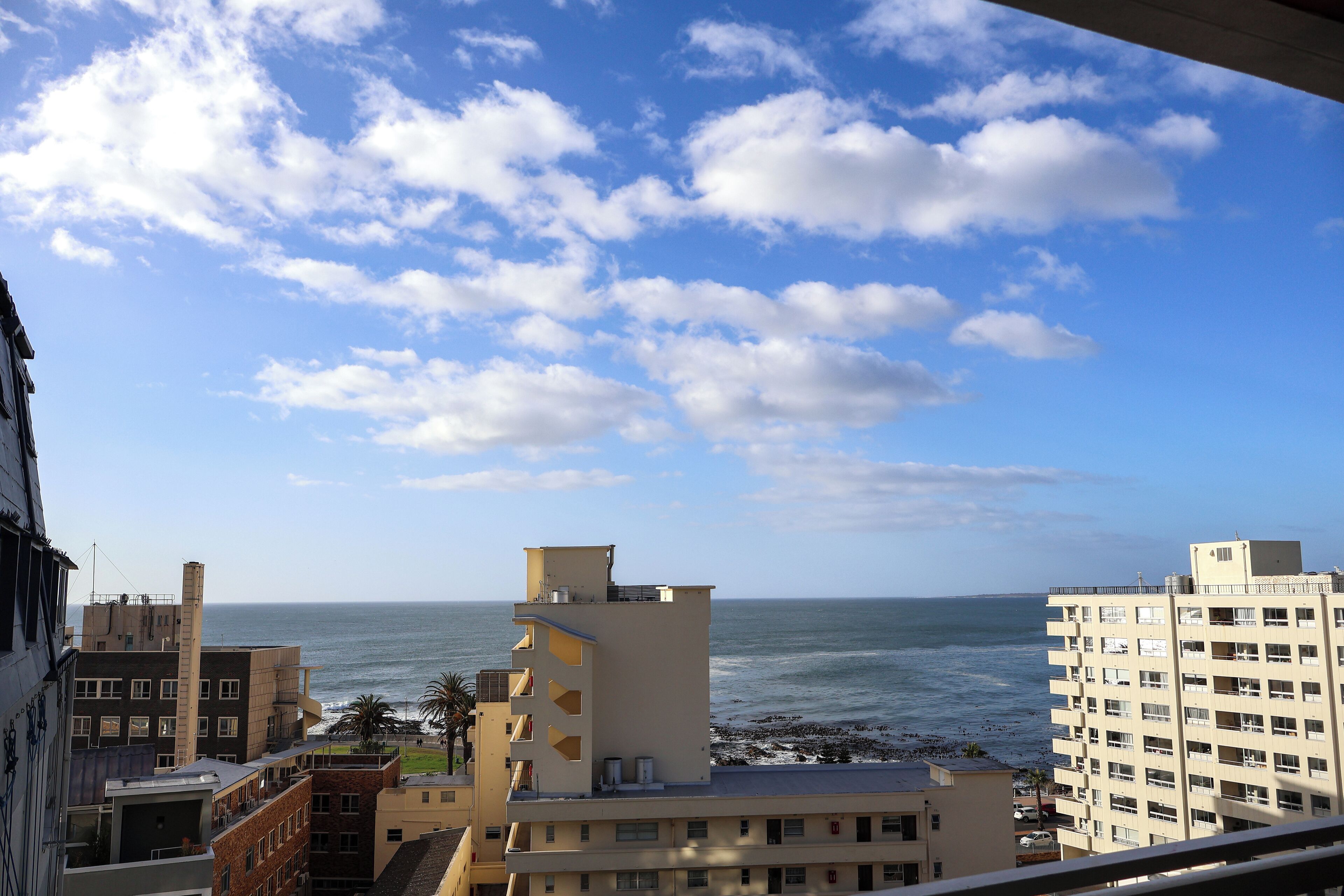 A coastal cityscape with buildings overlooking the sea.