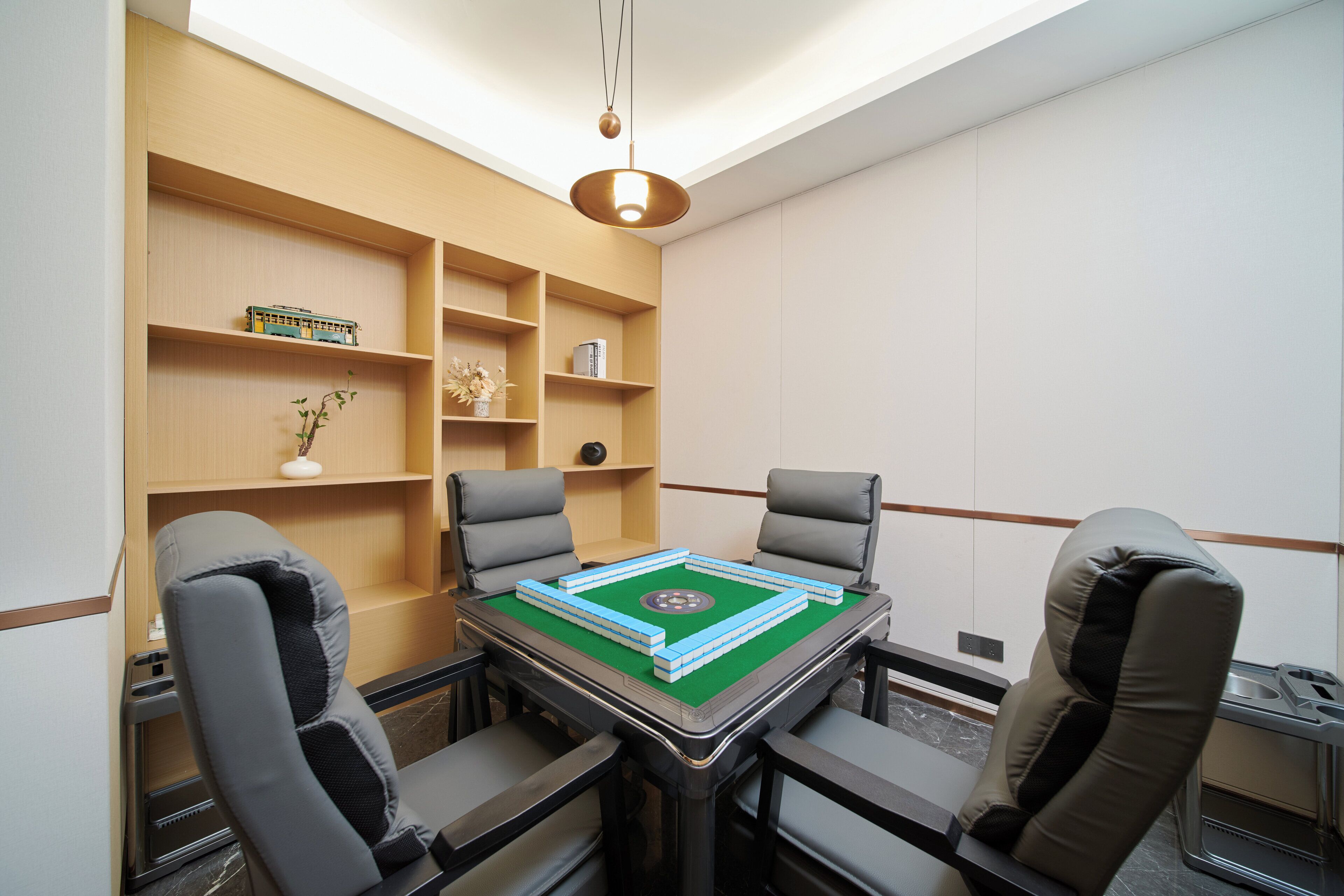 A conference room with a table, chairs, and shelves with various items.