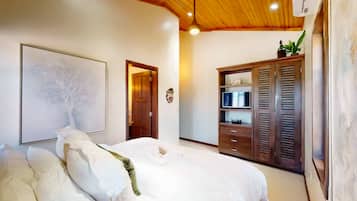 A bedroom with a bed, a wardrobe, and a ceiling light.