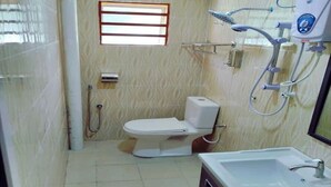 A bathroom with a toilet, shower, and sink. - Hotel O Puteri Miqaila (Bota)