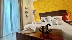 Une chambre d’hôtel avec un lit, une table de chevet sur laquelle se trouve un livre, une lampe et un objet décoratif.