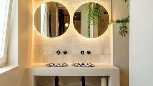A bathroom with two sinks, a mirror, and a plant. - Penthouse, pool & Valletta views | ROP by Homega (Sliema)