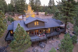 A cabin with a deck, surrounded by trees. - The Alpine Vista | Pets | Couples | Golf | Nakoma (Portola)