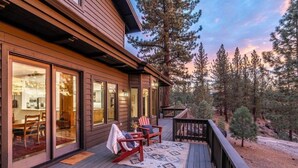 A wooden deck with a rug, two chairs, and a table. - The Alpine Vista | Pets | Couples | Golf | Nakoma (Portola)