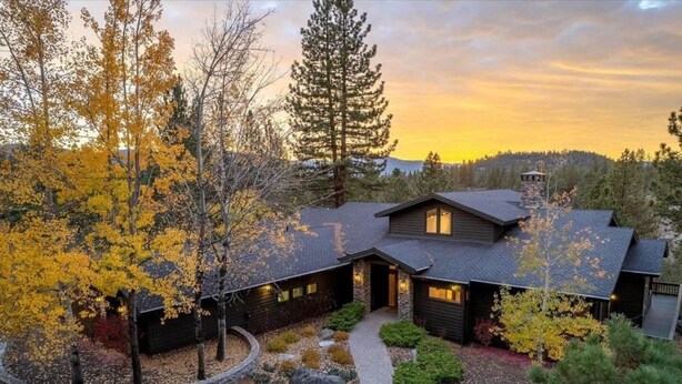A modern house with a stone facade, a covered porch, and a well-maintained garden with autumn foliage. - The Alpine Vista | Pets | Couples | Golf | Nakoma (Portola)
