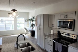 Fridge, microwave, oven, stovetop - Modern Omaha Getaway with Private Deck & Free Parking (Omaha)