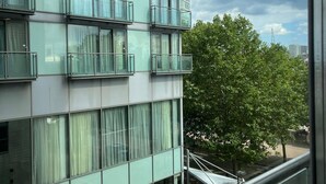 Un edificio moderno con varios pisos, ventanas amplias y balcones.