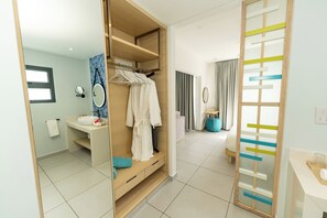 A modern bathroom with a wooden vanity, a mirror, and a towel rack.
