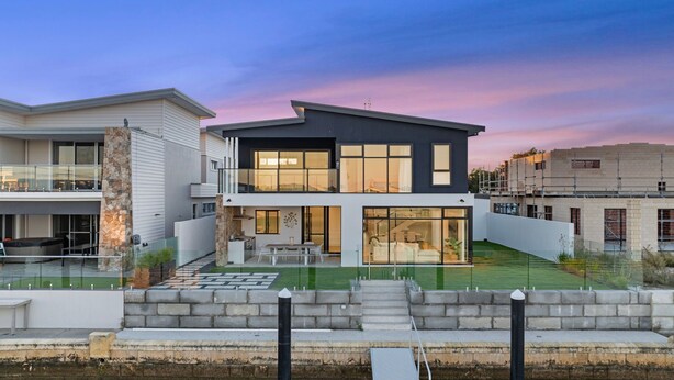 A modern two-story house with a balcony, a small patio, and a swimming pool. - Ultimate luxury on the canal (Geographe)