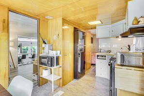 A compact kitchen with wooden cabinets, a refrigerator, a microwave, and a toaster. - Lake of the Ozarks Retreat w/ Dock & Sunset View! (Sunrise Beach)