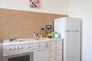 Een koelkast, een oven, een kookplaat, een koffiezetapparaat/waterkoker