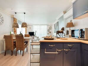 Enjoy cooking in this well-equipped kitchen with a central island, microwave, and ample storage.