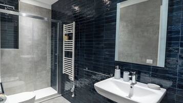 Shower, rainfall showerhead, hair dryer, towels