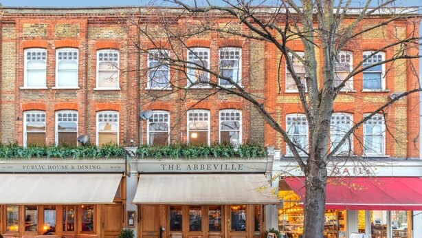 A brick building with multiple storefronts, including a public house and dining establishment named "The Abbaville". - Clapham 3-bed Flat, Sleeps 6 With Free Parking (London)