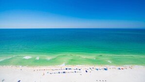 A beach with clear turquoise water and a sandy shore. - The Oasis 2708 Formerly Phoenix West Ii 2708 3 Bedroom Condo by RedAwning (Orange Beach)