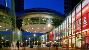 A modern building with a curved glass facade and a large, open interior space. - Zoetermeer City Centre Loft Apartment (Zoetermeer)