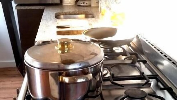 A kitchen with a stove, pots, a microwave, and a kettle. - Zoetermeer City Centre Loft Apartment (Zoetermeer)