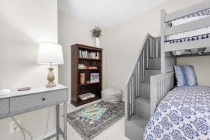 A bedroom with a bunk bed, a desk with a lamp, a bookshelf, and a rug. - S Exposure Waterfront Home | Near Beach/Food/Fun (Marco Island)