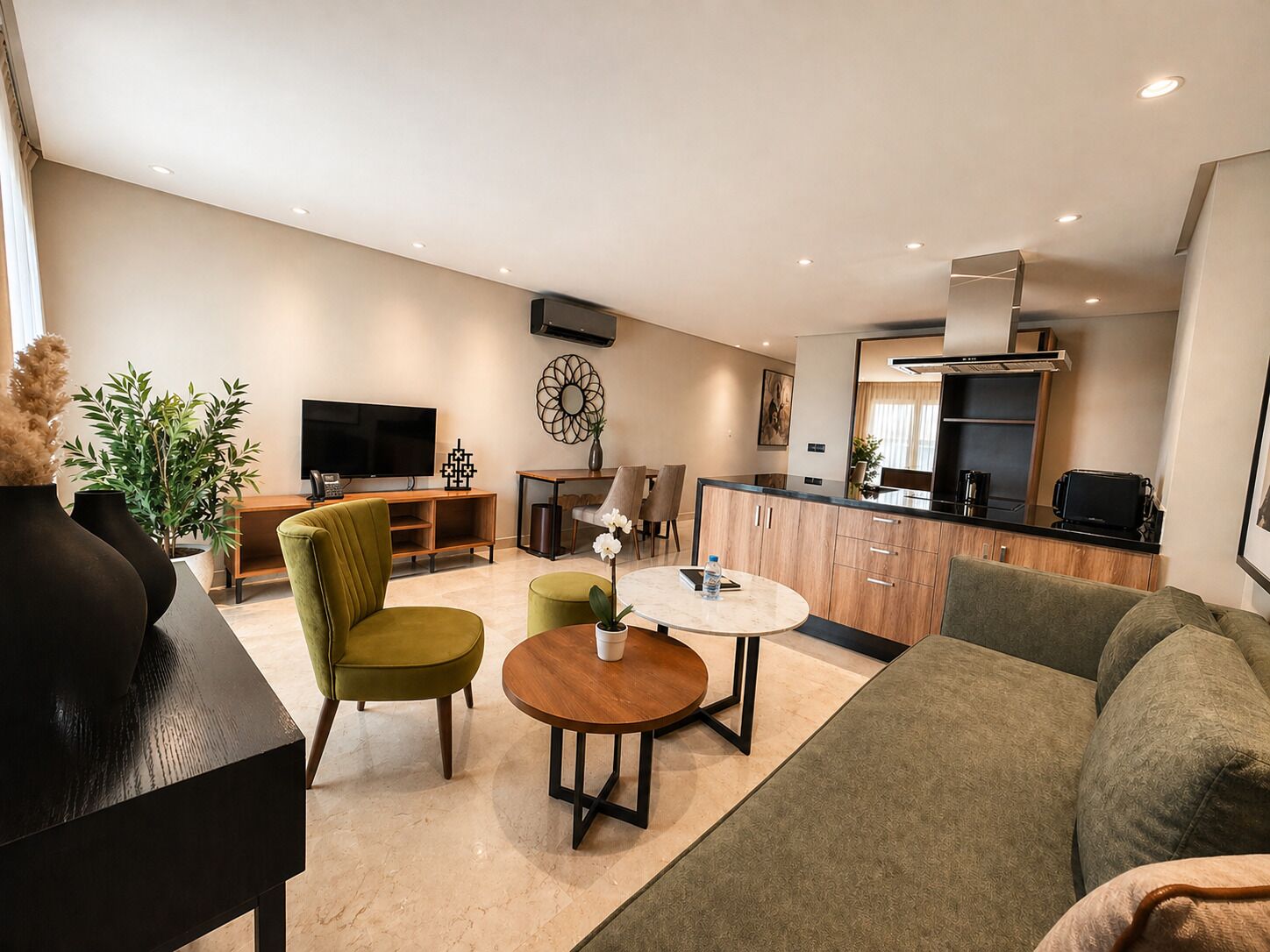 A modern living room with a sofa, a round table, and a TV.