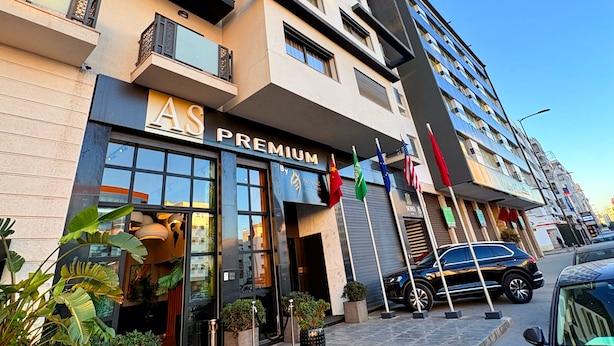 A multi-story hotel with a 'PREMIUM' sign, outdoor plants, and flags. - AS PREMIUM BY SOHO HOTELS (Casablanca)