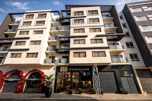 A multi-story hotel with a modern facade, balconies, and a storefront labeled 'AS PREMIUM'. - AS PREMIUM BY SOHO HOTELS (Casablanca)