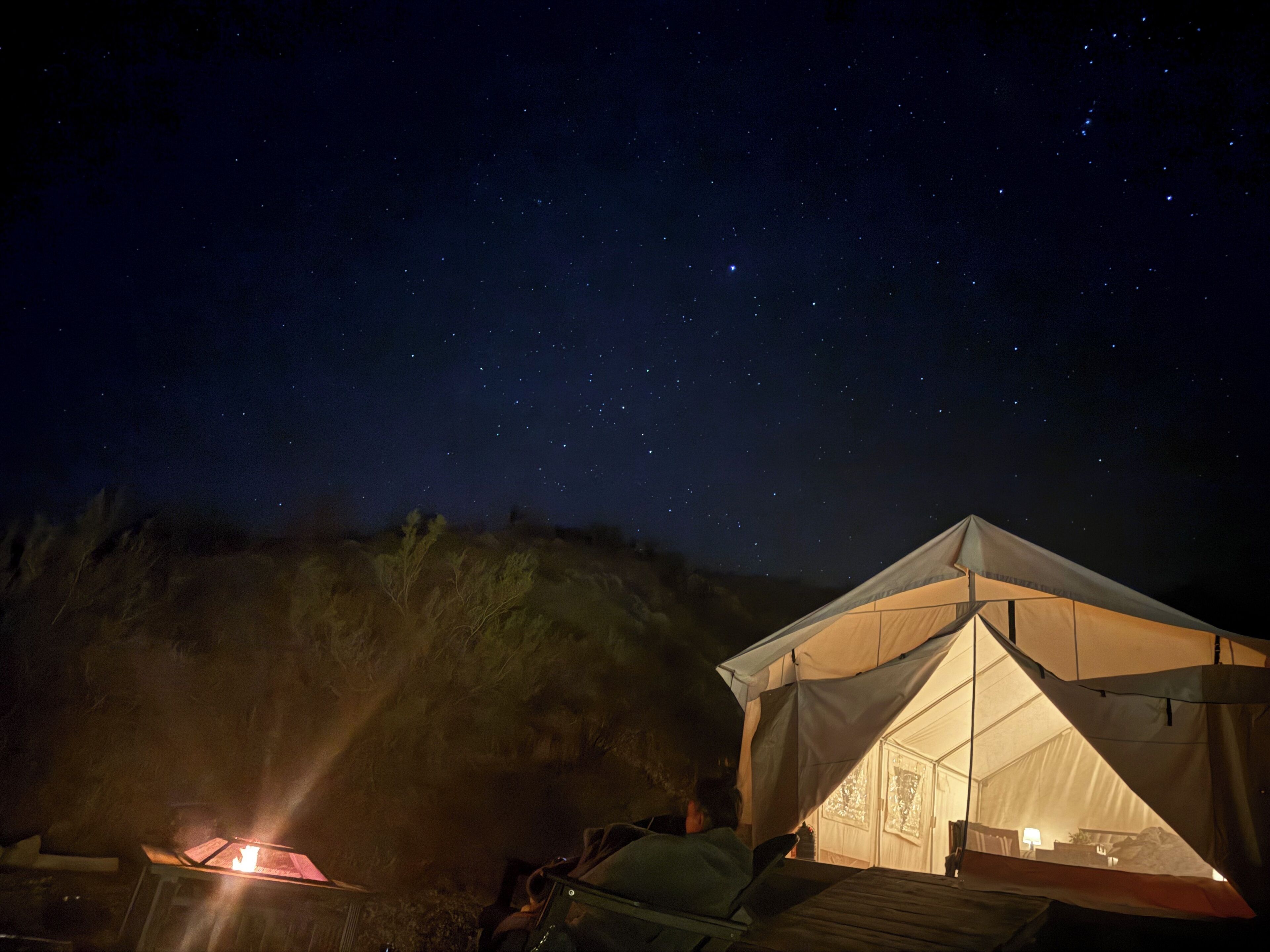 A tented accommodation with a clear view of the night sky.