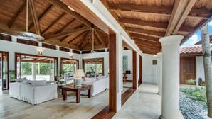 A spacious indoor area with a high wooden ceiling, white columns, and a stone floor. - Gorgeous Villa at Casa de Campo With Large Pool Chef Maid and 2 Golf Carts (La Romana)