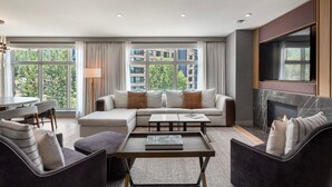A modern living room with a sectional sofa, a coffee table, and a fireplace. - Luxe Resort Penthouse - Ski in Ski Out 3 Bedroom (Snowmass Village)