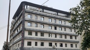 A multi-story building with a sign for 'Hotel Vikrant' and 'Kavya's Wholesale' on the ground floor. - hotel vikrant (Ludhiana)