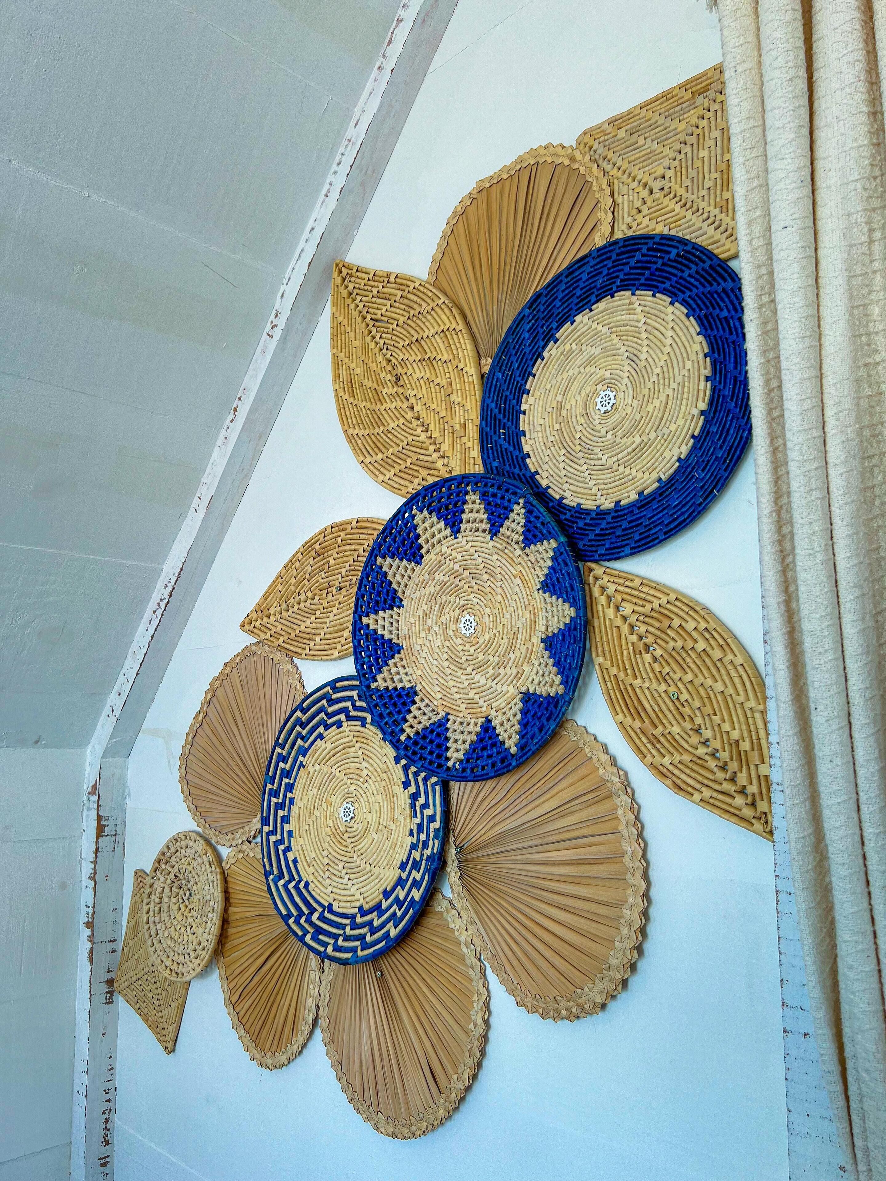 A wall with woven decorative panels in a geometric pattern.