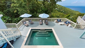 A rooftop pool area with lounge chairs, umbrellas, and a hot tub. - The Villa Michelle•Luxury•Ocean Views•Heated Salt Pool•Outdoor Living (St Thomas)